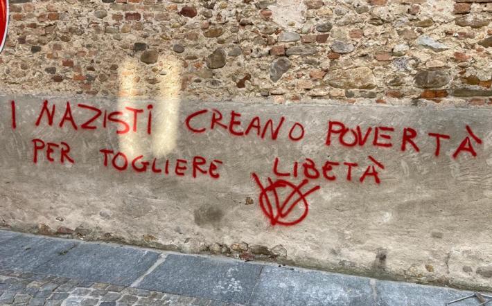 Vandali di nuovo in azione a Piozzo: scritta con lo spray sulla parete della chiesa parrocchiale